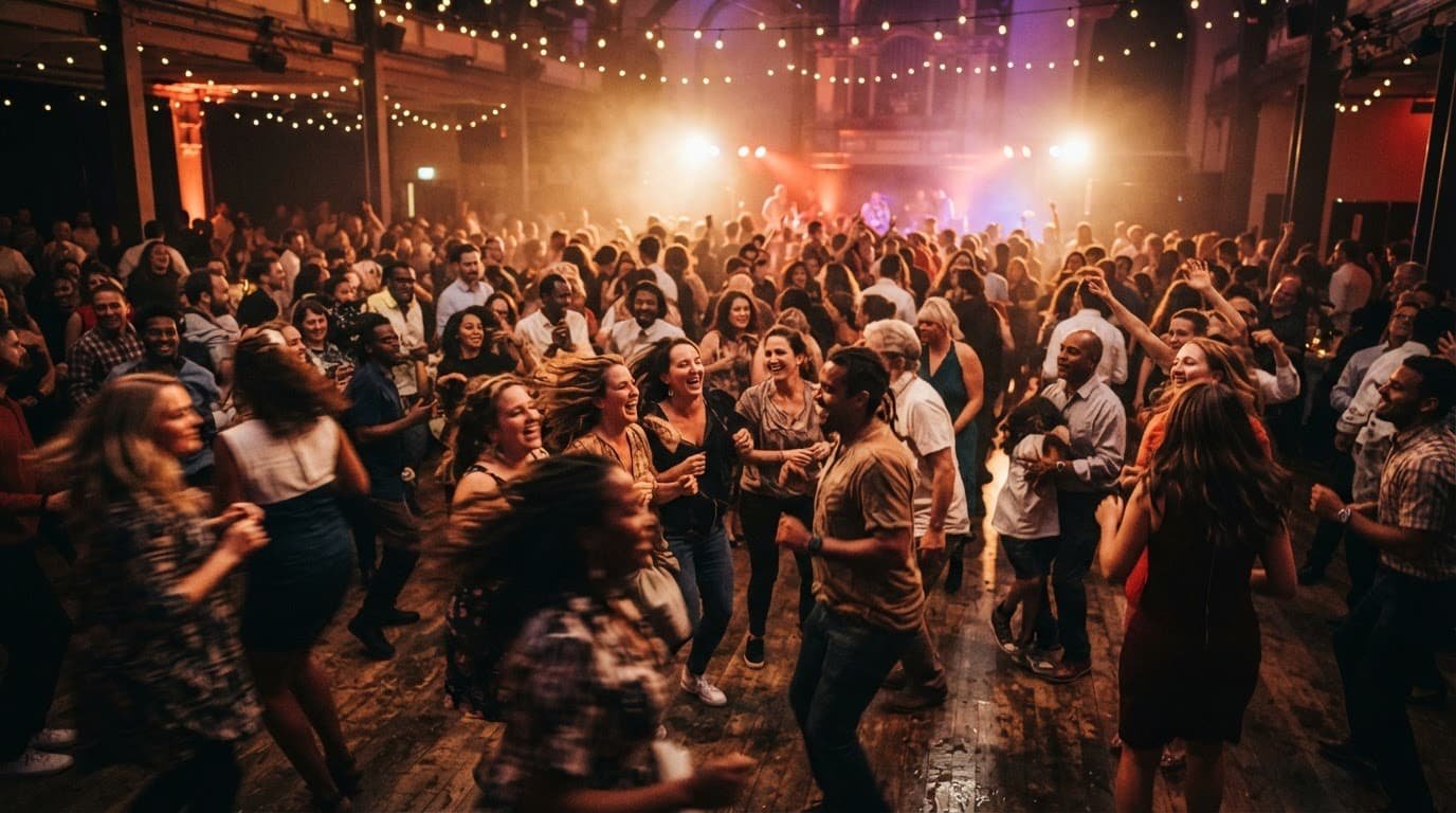 Concord NH DJ Guide for Better Community Events Joyful people dance together beneath warm lights in a spacious hall.
