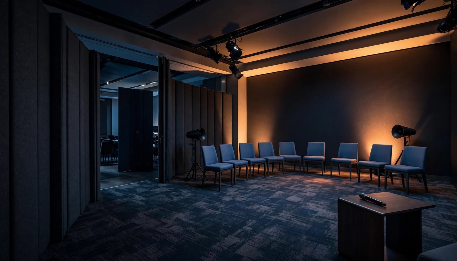 Breakout Room Audio for Corporate Events and Concurrent Sessions Two speakers and a microphone sit beside fabric partitions in a hotel conference room.